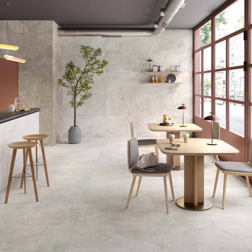 Modern kitchen and dining area with large windows, neutral color palette, and minimal decor.