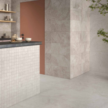 Modern kitchen with tiled walls, a countertop, and decorative elements.