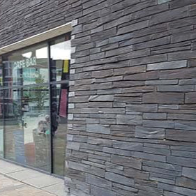 Modern building exterior with glass facade and wooden paneling