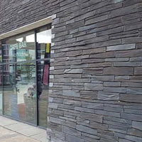 Modern building exterior with glass facade and wooden paneling