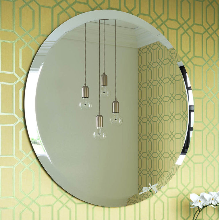 Round mirror on a wall with geometric pattern, sink, and decorative elements.