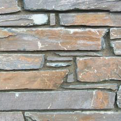 Close-up of a stone wall with stacked stone pattern