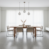 Modern dining room with a wooden table and chairs, featuring pendant lights and a vase.