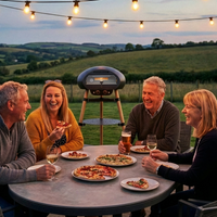 Two couples enjoying pizza and drinks outdoors with string lights and a scenic background.